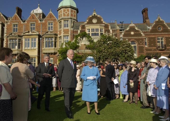 SANDRINGHAM, ENGLAND - JULY 18:  Queen Elizabeth II, accompanied by Sir Timothy Colman of Colman's Mustard, hosts a Garden Party  at Sandringham House in Norfolk on July 18, 2002 in Sandringham,  England. (Photo by Pool/ Anwar Hussein/Getty Images)