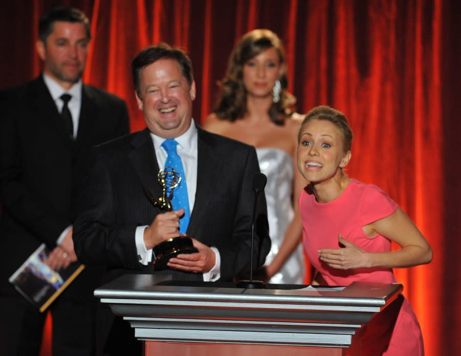 Sam Rubin and Jessica Holmes accept award for best morning newscast on stage at the Television Academys 66th Los Angeles Area Emmy Awards on Saturday, July 26, 2014 at The Leonard H. Goldenson Theater in the NoHo Arts District in Los Angeles. (Photo by Vince Bucci/Invision for the Television Academy/AP Images)
