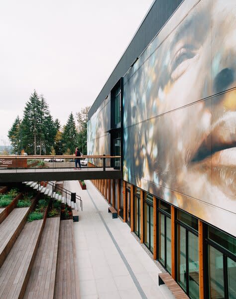 A 3,000-square-foot mural by artist Guido van Helten overlooks the entrance of the PorchLight Eastgate shelter.