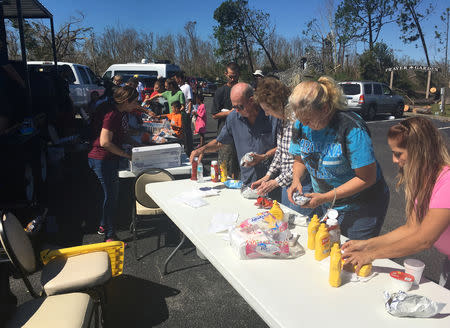 Catholic Church volunteers serve lunch to people affected by Hurricane Michael, in Callaway, Florida, U.S., October 13, 2018. REUTERS/Rod Nickel