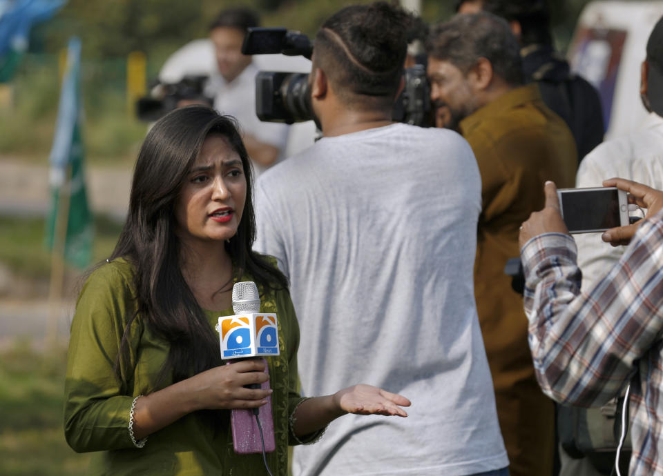 In this Friday, Sept. 11, 2020 photo, Alena Waqar, a female journalist from local tv channel Geo News, gives live reporting during a rally, in Islamabad, Pakistan. Social media attacks against Pakistan's women journalists have been vile and vicious, some threatening rape, others even threatening death and the culprits are most often allied to the ruling party, even prompting the Committee to Protect Journalists to issue a statement on Friday condemning the relentless attacks. (AP Photo/Anjum Naveed)