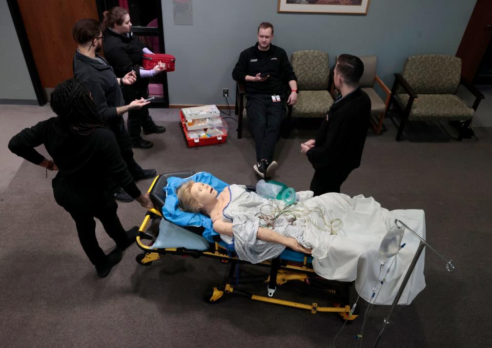 Paramedic students Autumn Anderson, left, Stephen Henderson, Ally Suida, Travis Sparling and Ryan Rivard talk while assessing a mannequin during scenario training at the Medstar offices in Clinton Township on Wednesday, Nov. 1, 2023. Sparling, a paramedic, was putting the other four through a test to see if they knew the steps to take when presented with a patient who in this scenario was at home complaining of lightheadedness.