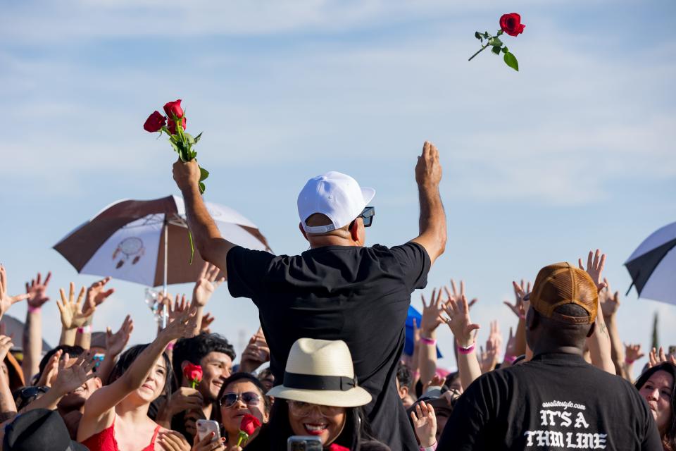 American rapper, songwriter and record producer MC Magic gives away roses to fans when he performs at the Higherlevels Carshow and Concert on Sunday, July 16, 2023, at Ascarate Park in El Paso.