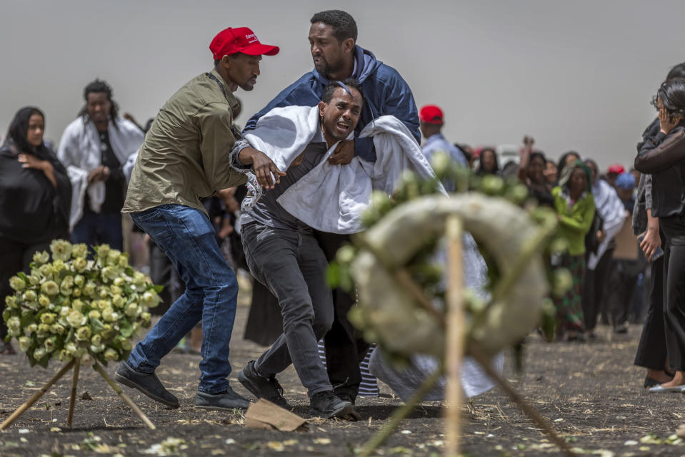 Ethiopian relatives of crash victims mourn and grieve at the scene where the Ethiopian Airlines Boeing 737 Max 8 crashed shortly after takeoff on Sunday killing all 157 on board, near Bishoftu, south-east of Addis Ababa, in Ethiopia Thursday, March 14, 2019. About 200 family members of people who died on the crashed jet stormed out of a briefing with Ethiopian Airlines officials in Addis Ababa on Thursday, complaining that the airline has not given them adequate information. (AP Photo/Mulugeta Ayene)