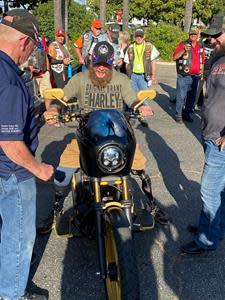 Georgia Marine veteran Tony Mullis checks out a custom 1993 FXR Harley Davidson that Wounded Warriors Family Support provided him during a Combat Hero Bike Build Presentation Monday night.