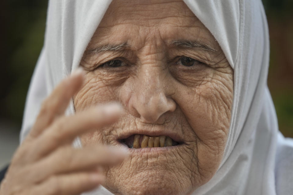 Amina Saleh Taher, 79, speaks during an interview with the Associated Press at the Palestinian refugee camp of Shatila in Beirut, Lebanon, Wednesday, May 15, 2024. Taher recalled the day her family's house in the village of Deir al-Qassi, in today's northern Israel, collapsed over their heads after being shelled by Israeli forces in 1948. The house was next to a school that was being used as a base by Palestinian fighters, she said. The Nakba, Arabic for "catastrophe," refers to the 700,000 Palestinians who fled or were driven out of what today is Israel before and during the war surrounding its creation in 1948. (AP Photo/Hassan Ammar)