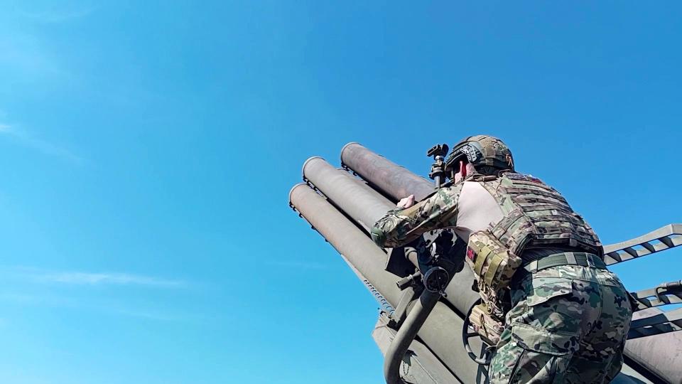 A Russian soldier launching a missile pointed toward the sky.