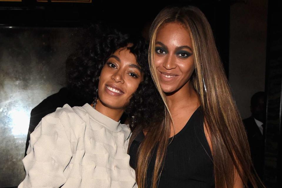 <p>Kevin Mazur/Getty</p> Solange Knowles and Beyoncé.