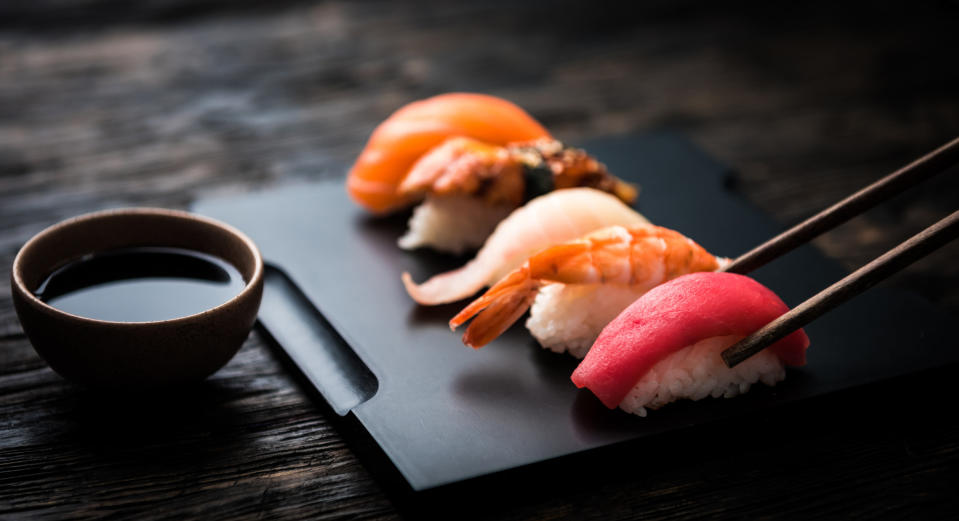 Various pieces of sushi and soy sauce.