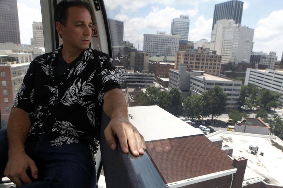 Bryan Jackson, of Atlanta, gets one of the first rides on SkyView, a 200-foot tall Ferris wheel Tuesday, July 16, 2013, in Atlanta. The giant Ferris wheel opened Tuesday to the public and gives rides in climate-controlled gondolas. (AP Photo/Jaime Henry-White)