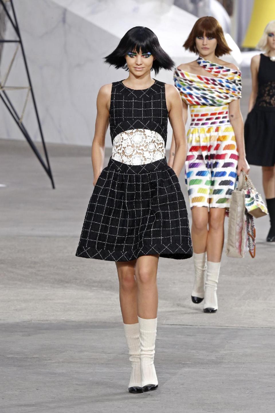 Model Miranda Kerr, foreground, presents a creation as part of Chanel's ready-to-wear Spring/Summer 2014 fashion collection, presented Tuesday, Oct. 1, 2013 in Paris. (AP Photo/Jacques Brinon)