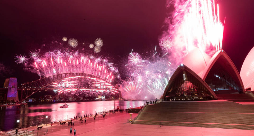 The Sydney Harbour fireworks display is seen over a near-empty Sydney Opera House forecourt. Source: Brook Mitchell/Getty Images