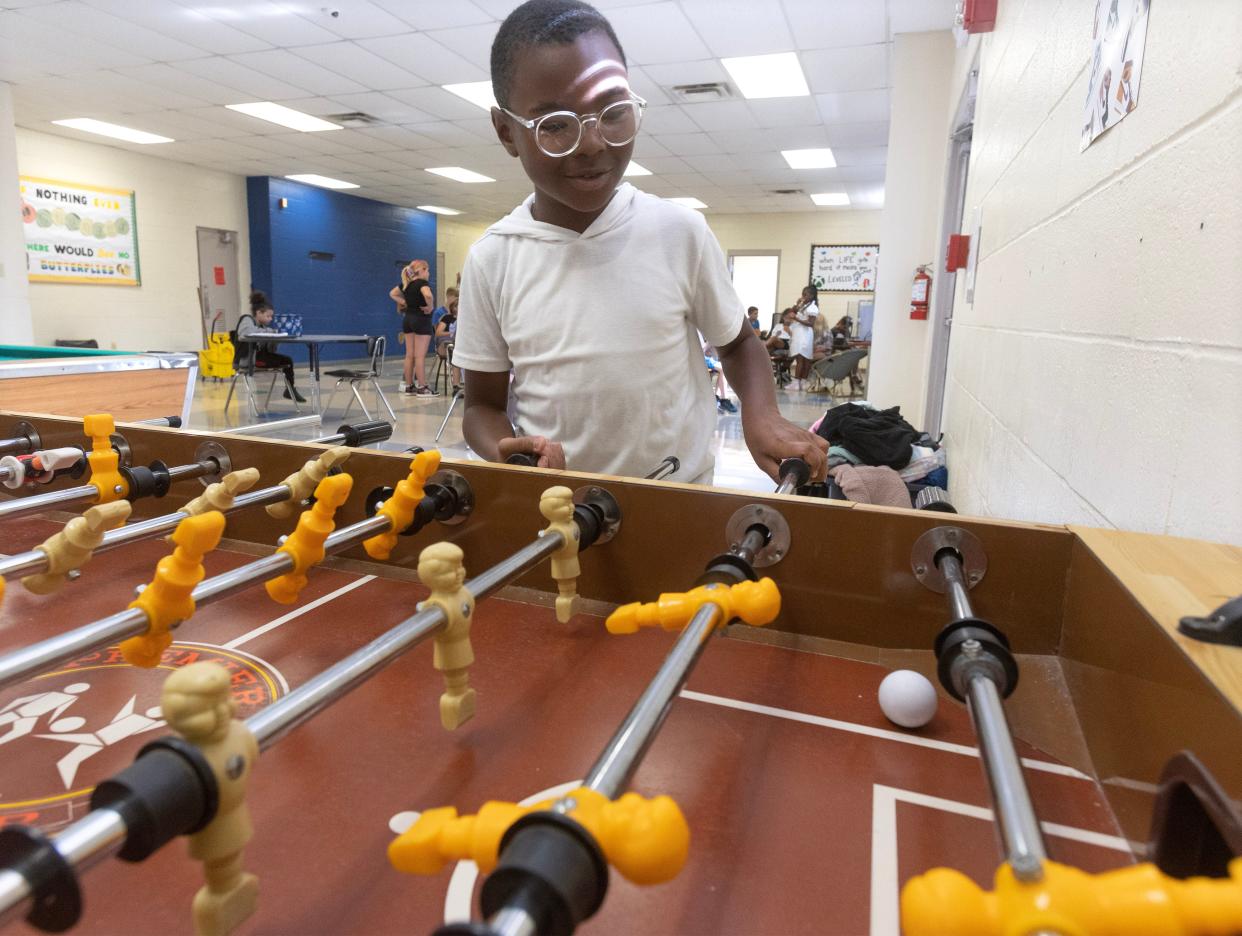 Kyree Campbell, 10, plays a game of foosball at the Massillon Boys and Girls Club.