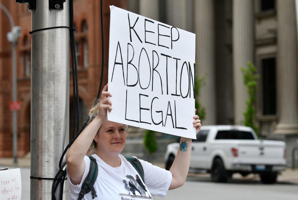 Krystle Feathers of Louisville holds up a sign to show her support during a pro-choice rally outside the Hall of Justice, Tuesday, May. 3, 2022 in Louisville, Ky.