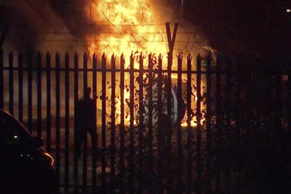 This image made from video shows a burning helicopter in a parking lot outside the King Power Stadium in Leicester, England shortly after a Premier League game on Saturday, Oct. 27, 2018. (Pool Photo via AP)