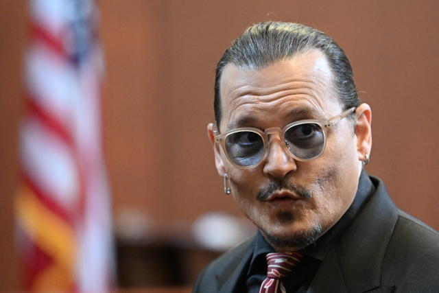 Actor Johnny Depp arrives in the courtroom at the Fairfax County Circuit Court in Fairfax, Va., Tuesday May 3, 2022. Depp sued his ex-wife Amber Heard for libel in Fairfax County Circuit Court after she wrote an op-ed piece in The Washington Post in 2018 referring to herself as a "public figure representing domestic abuse." (Jim Watson/Pool photo via AP)