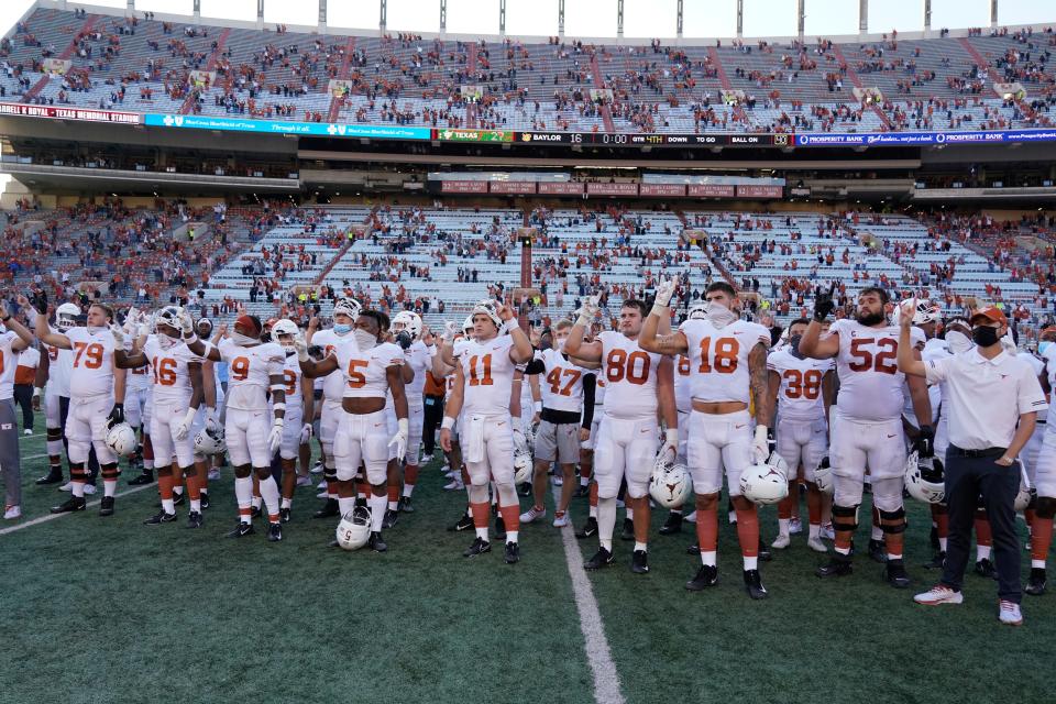 Texas players, including Sam Ehlinger (11), sing "The Eyes Of Texas" after the Oct. 24, 2020 against Baylor in Austin, Texas.