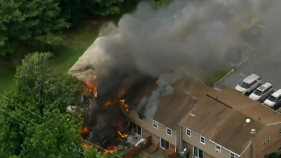 Several townhomes went up in flames after a homeowner allegedly pulled a gun on a local code enforcement officer on Thursday, June 10.  / Credit: KYW