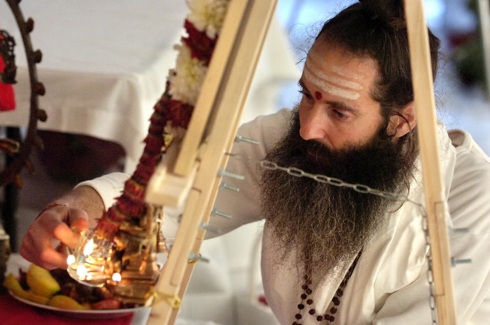 Man lights an offering