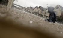 <p>A child makes his way through floodwaters from Tropical Storm Harvey while checking on neighbors at his apartment complex in Houston, Sunday, Aug. 27, 2017. (Photo: LM Otero/AP) </p>