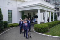 President Joe Biden walks out of the White House with Senators to speak Thursday, June 24, 2021, in Washington. (AP Photo/Evan Vucci)