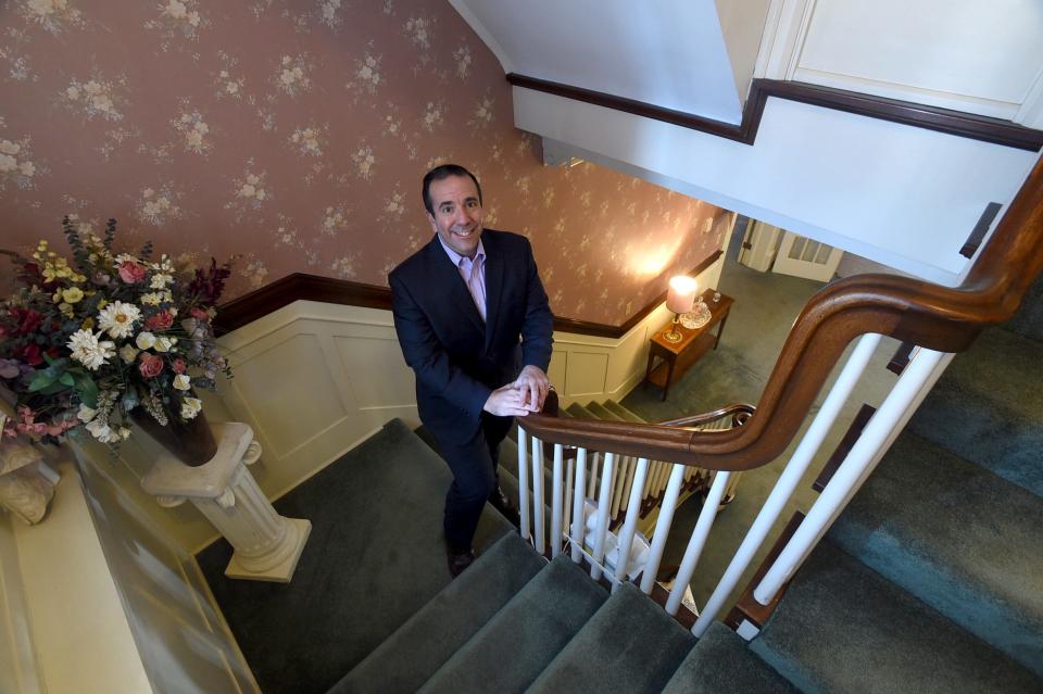 Garrett S. Shames of Glowacki Management Co. stands in a stairwell inside the W. James Scott Jr Funeral Home. Shames is assisting proprietor Jim Scott in his efforts to lease or reuse the now-vacant funeral home.