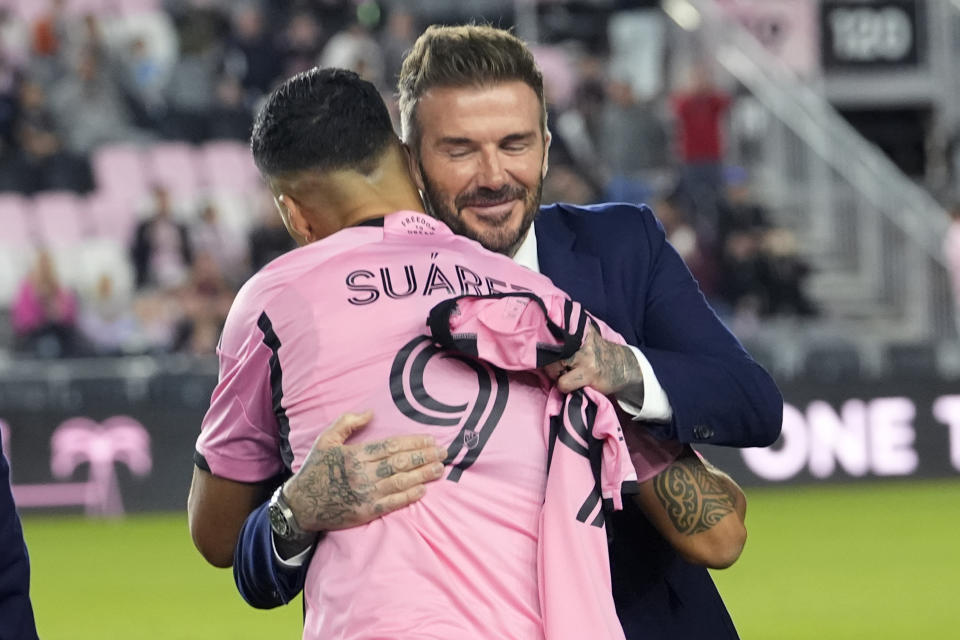 Inter Miami co-owner David Beckham, right, hugs forward Luis Suarez (9) before the team's MLS soccer match against Real Salt Lake, Wednesday, Feb. 21, 2024, in Fort Lauderdale, Fla. (AP Photo/Lynne Sladky)