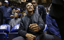 Former President Barack Obama joins fans during an NCAA college basketball game between Duke and North Carolina in Durham, N.C., Wednesday, Feb. 20, 2019. (AP Photo/Gerry Broome)