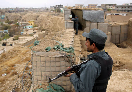 Afghan police officers keep watch at their forward base on the outskirts of Kunduz province, Afghanistan November 26, 2017. REUTERS/Nasir Wakif