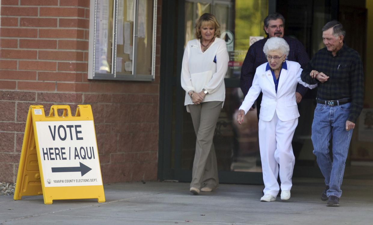 Jerry Emmett, who was born before women won the right to vote in the U.S., leaves the Yavapai County Administration Building with her son Jim, Yavapi County Recorder Leslie Hoffman and Jack Fields assistant Yavapai County administrator after casting her early ballot in the 2016 presidential election.