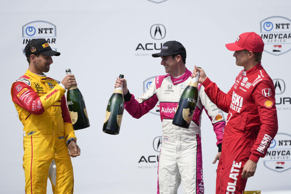 Race winner Kyle Kirkwood, center, celebrates with second-place Romain Grosjean, left, of Switzerland, and third-place Marcus Ericsson during the victory ceremony for the IndyCar Grand Prix of Long Beach auto race Sunday, April 16, 2023, in Long Beach, Calif. (AP Photo/Jae C. Hong)