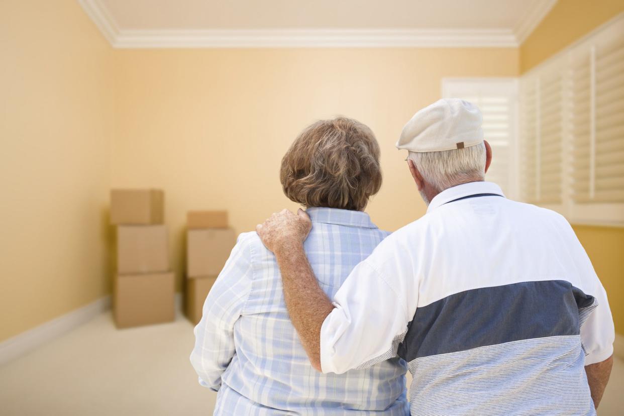 senior couple looking at moving boxes