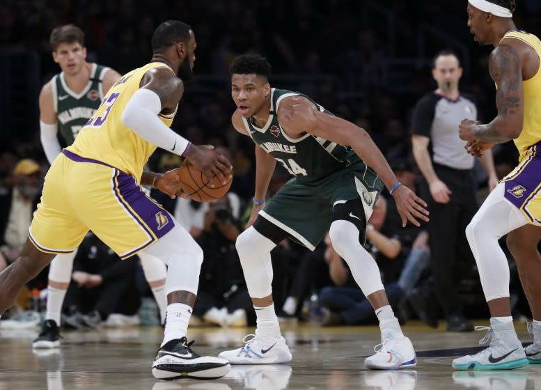 LOS ANGELES, CALIF. -- FRIDAY, MARCH 6, 2020: Los Angeles Lakers forward LeBron James (23) is guarded by Milwaukee Bucks forward Giannis Antetokounmpo (34) in the first half at the Staples Center in Los Angeles, Calif., on March 6, 2020. (Gary Coronado / Los Angeles Times)