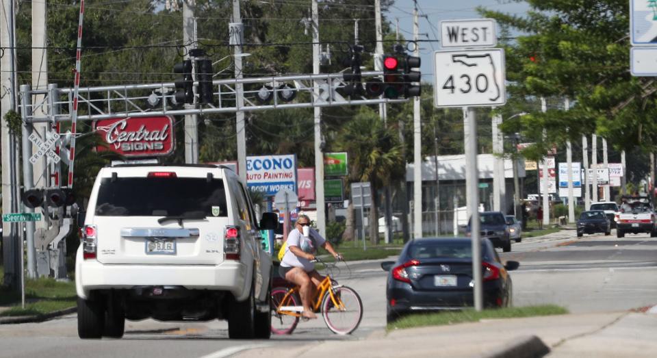 At their meeting Wednesday night, Daytona Beach city commissioners got an update from Florida Department of Transportation officials on  the Mason Avenue Corridor Planning Study. Pictured is a bicyclist crossing Mason Avenue while vehicles wait at the Carswell Avenue intersection for a green light.