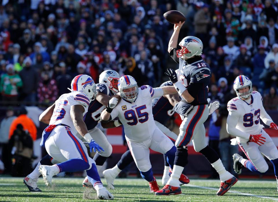 New England Patriots quarterback Tom Brady (12) drops back to pass against the Buffalo Bills in the first quarter at Gillette Stadium.
