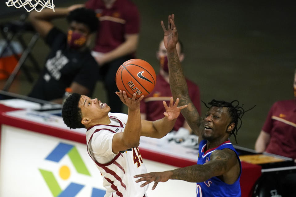 Iowa State guard Rasir Bolton drives to the basket in front of Kansas guard Marcus Garrett, right, during the second half of an NCAA college basketball game, Saturday, Feb. 13, 2021, in Ames, Iowa. Kansas won 64-50. (AP Photo/Charlie Neibergall)