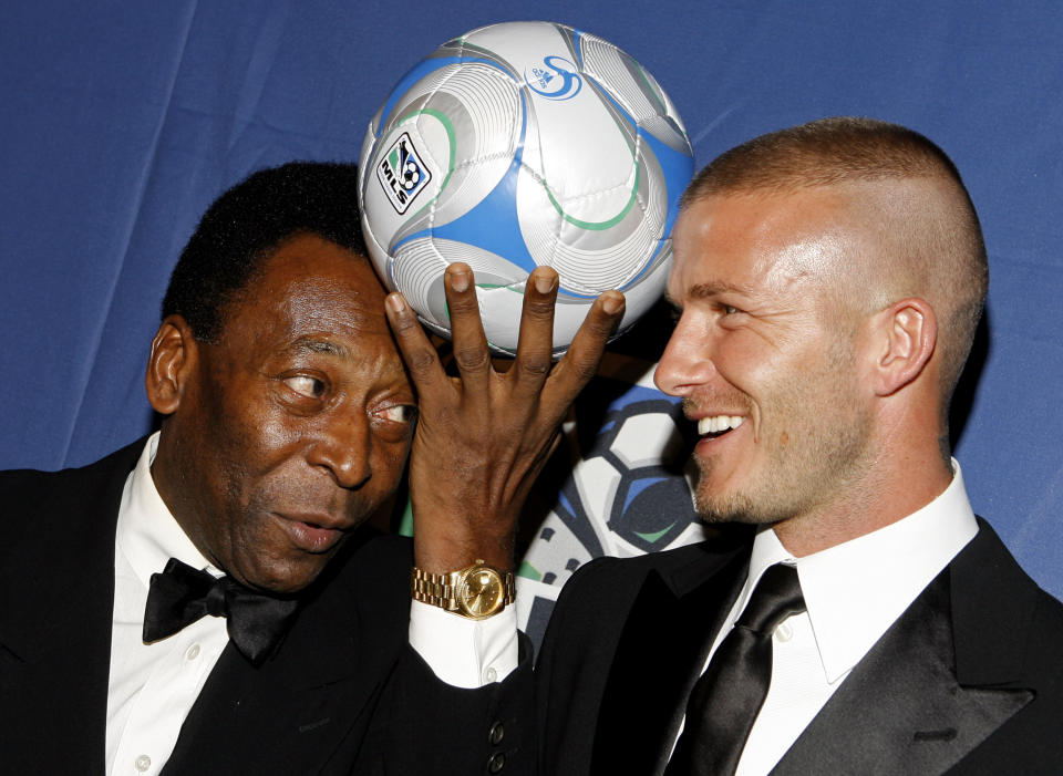 FILE - Brazilian soccer great Pele, and English soccer star David Beckham pose for photos during a U.S. Soccer Foundation fundraising gala, in New York, March 19, 2008. Pelé, the Brazilian king of soccer who won a record three World Cups and became one of the most commanding sports figures of the last century, died in Sao Paulo on Thursday, Dec. 29, 2022. He was 82. (AP Photo/Jason DeCrow, File)