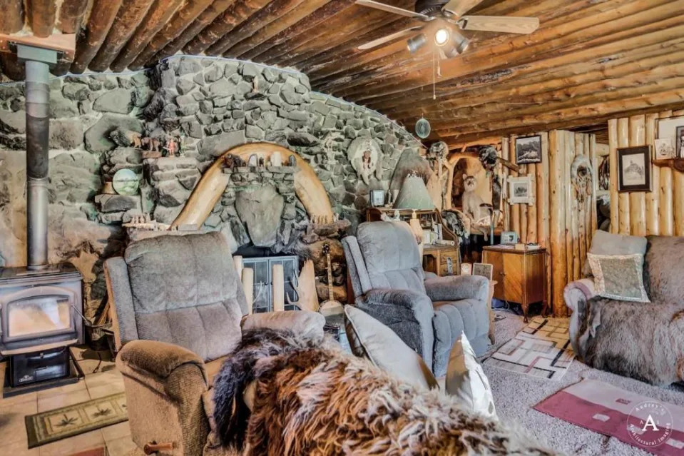 A sitting area anchored by a handsome stone wall. Audrey Todd Davis