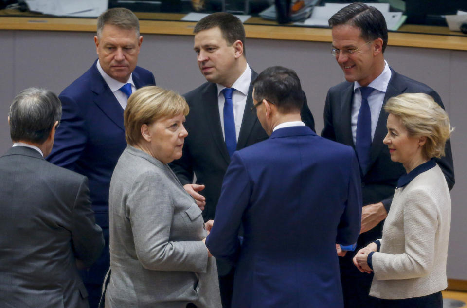 German Chancellor Angela Merkel, third left, speaks with Polish Prime Minister Mateusz Morawiecki, third right, during a round table meeting at an EU summit in Brussels, Friday, Dec. 13, 2019. European Union leaders are gathering Friday to discuss Britain's departure from the bloc amid some relief that Prime Minister Boris Johnson has secured an election majority that should allow him to push the Brexit deal through parliament. (Julien Warnand)