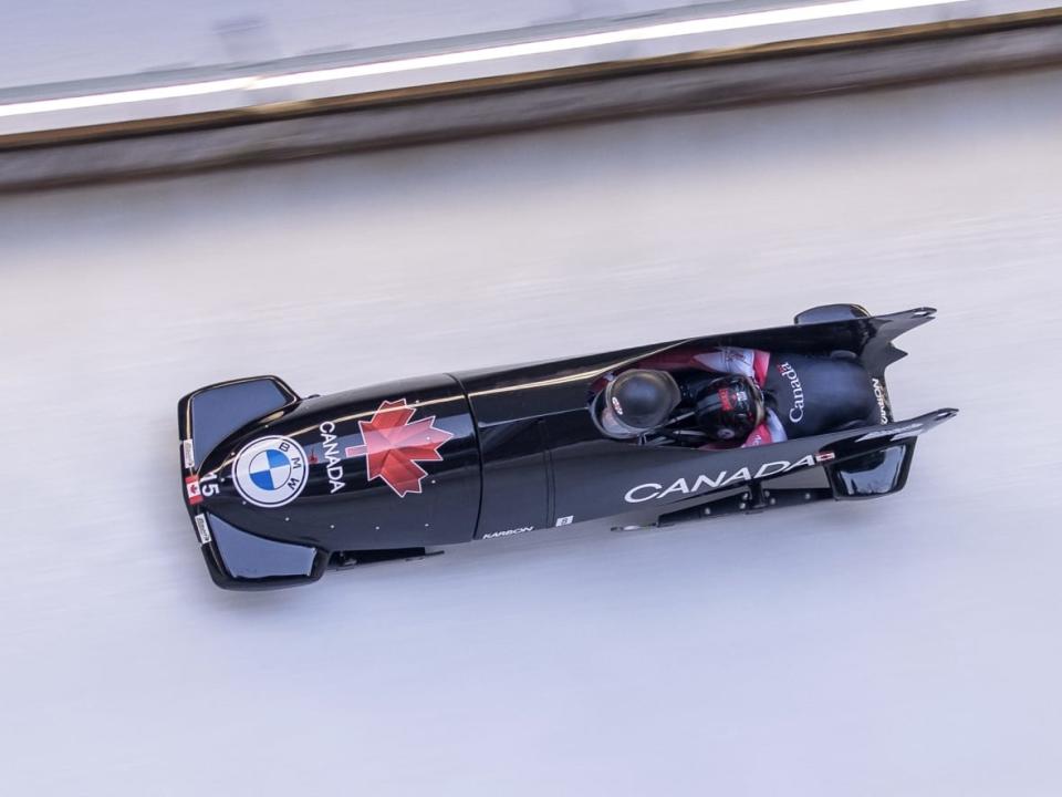 Canada's Christine de Bruin and Kristen Bujnowski compete during the first run of the women's bobsleigh event in Innsbruck, Austria, on Sunday. (Johann Groder/Getty Images - image credit)