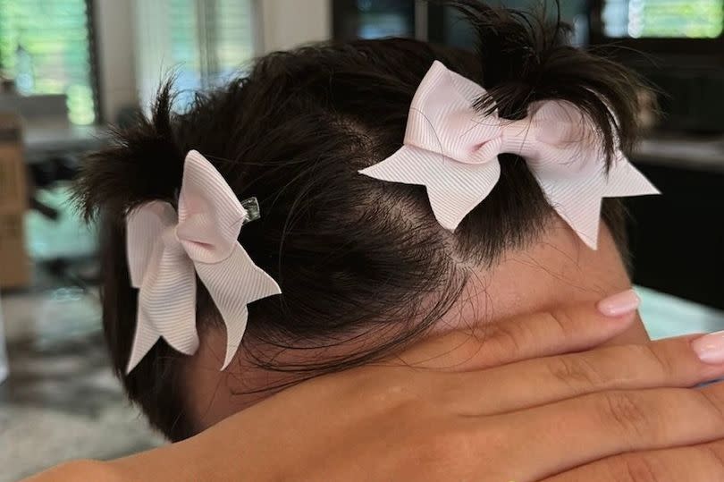 Tommy Fury with bows in his hair