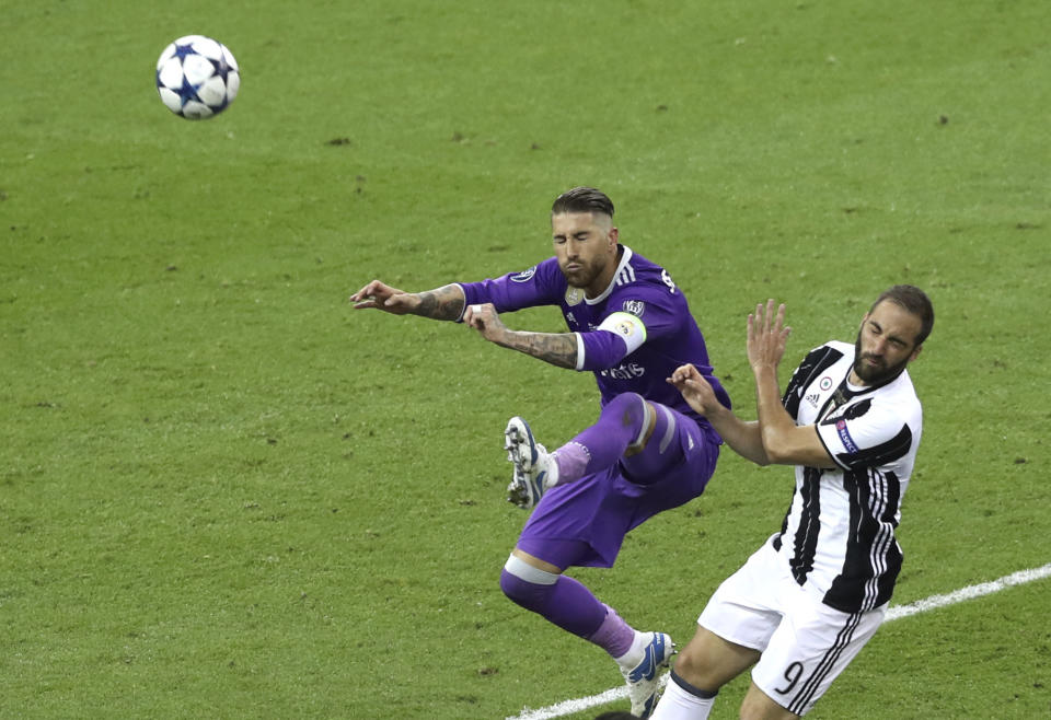 <p>Real Madrid’s Sergio Ramos jumps for the ball against Juventus’ Gonzalo Higuain during the Champions League Final soccer match between Juventus and Real Madrid at the Millennium Stadium in Cardiff, Wales, Saturday, June 3, 2017. (AP Photo/Alastair Grant) </p>