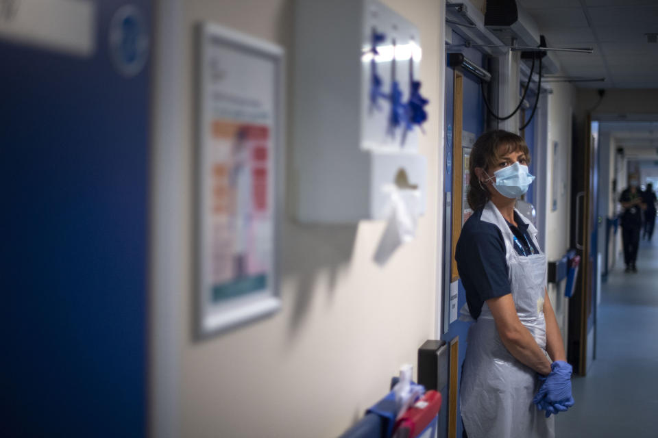 A support worker stands in a corridor as the first patients are admitted to the NHS Seacole Centre at Headley Court, Surrey