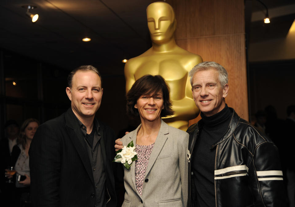 Kirk DeMicco, left, and Chris Sanders, right, co-directors of the Oscar-nominated animated feature film "The Croods," pose with producer Kristine Belson at a reception featuring the Oscar nominees in the Animated Feature Film category on Friday, Feb. 28, 2014, in Beverly Hills, Calif. The 86th Oscars ceremony will be held on Sunday at the Dolby Theatre in Los Angeles. (Photo by Chris Pizzello/Invision/AP)