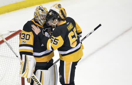 May 21, 2017; Pittsburgh, PA, USA; Pittsburgh Penguins defenseman Ron Hainsey (65) celebrates with goalie Matt Murray (30) after beating the Ottawa Senators in game five of the Eastern Conference Final of the 2017 Stanley Cup Playoffs at PPG PAINTS Arena. Mandatory Credit: Don Wright-USA TODAY Sports