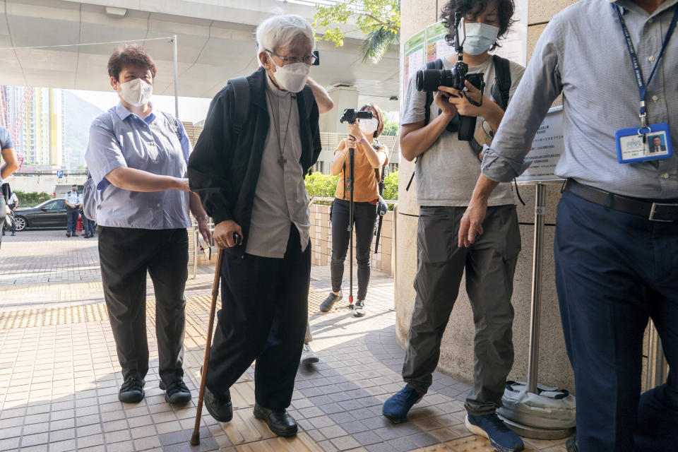 Cardinal Joseph Zen, center, arrives at the West Kowloon Magistrates' courts in Hong Kong Monday, Sept. 26, 2022. The 90-year-old Catholic cardinal and five others stood trial in Hong Kong on Monday for allegedly failing to register a now-defunct fund set up to assist people arrested in the mass anti-government protests in the city three years ago. (AP Photo/Oiyan Chan)