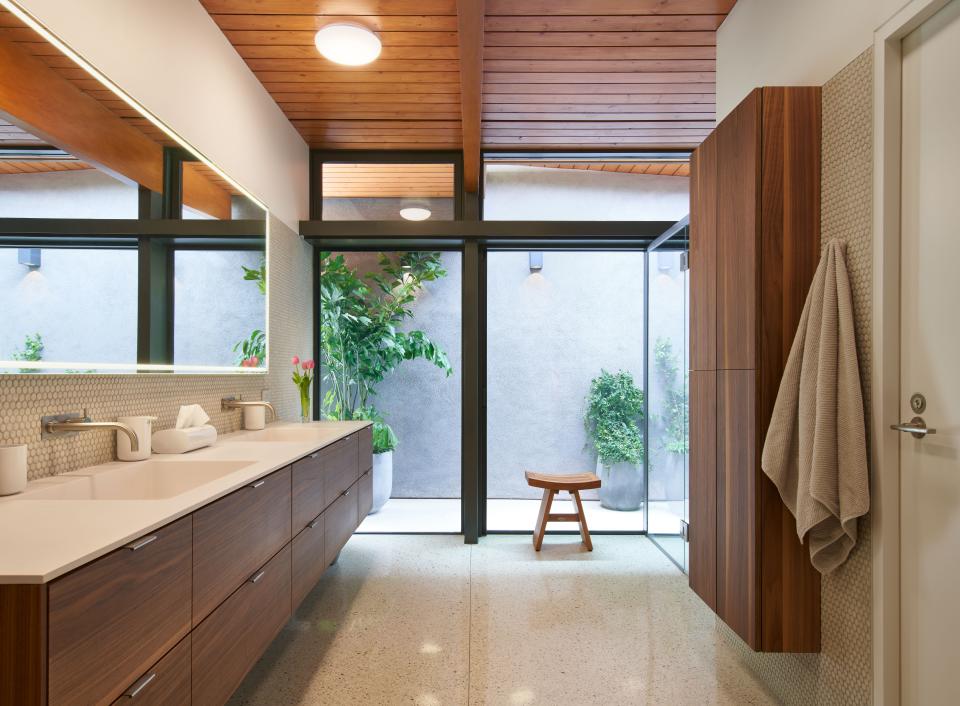 A small private courtyard is accessible from the primary bathroom. The shower is glassed on two sides so that it feels like an outdoor area.