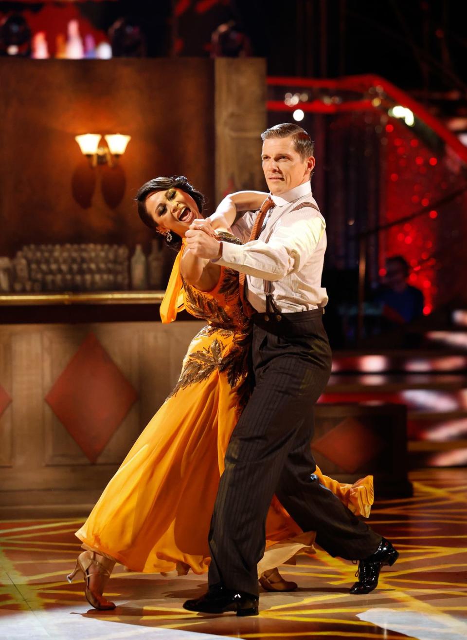 strictly come dancing 2023, nigel harman and katya jones foxtrot, katya is wearing a long orange dress and nigel is wearing a white shirt, black trousers and braces