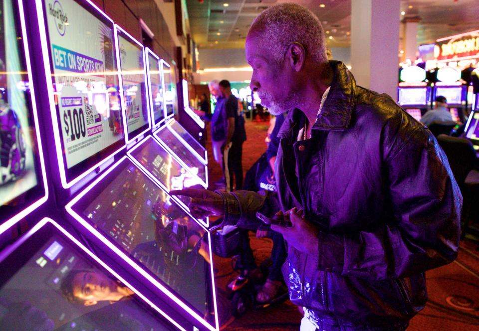 Willie Smith places a bet at a kiosk in the sports book at the Seminole Casino Hotel Immokalee on Monday.