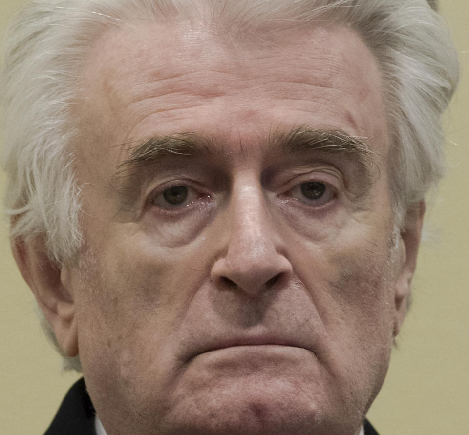 Former Bosnian Serb leader Radovan Karadzic enters the court room of the International Residual Mechanism for Criminal Tribunals in The Hague, Netherlands, Wednesday, March 20, 2019. Nearly a quarter of a century since Bosnia's devastating war ended, Karadzic is set to hear the final judgment on whether he can be held criminally responsible for unleashing a wave of murder and destruction. United Nations appeals judges will on Wednesday rule whether to uphold or overturn Karadzic's 2016 convictions for genocide, crimes against humanity and war crimes, as well as his 40-year sentence. (AP Photo/Peter Dejong, Pool)